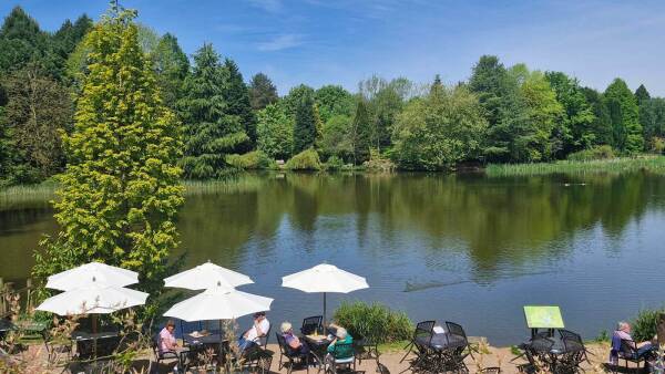 Sunny day at at the Bodenham lakeside cafe, with visitors enjoying the view in the outdoor seating area.